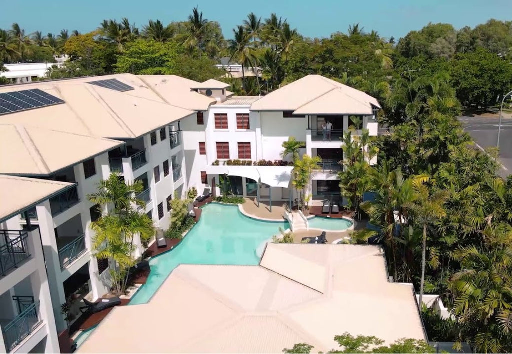 Meridian Port Douglas Resort Accommodation with a pool surrounded by greenery